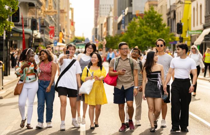 A group of international students walking down Rundle Street in Adelaide